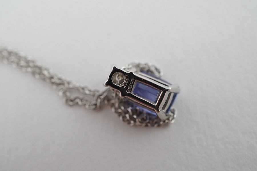 A modern 18ct white gold, tanzanite and diamond set pendant, 10mm, on an 18ct white gold chain, 39cm, gross weight 3.1 grams. Condition - good